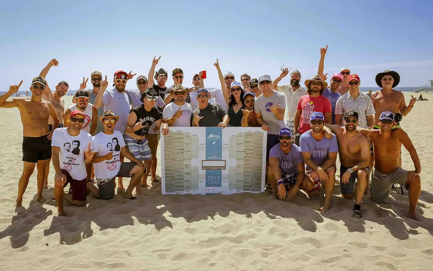 The bocce league crew celebrating on the beach behind the 2017 finals bracket.